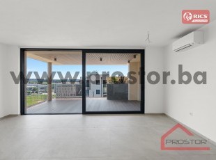 Luxurious and spacious two-bedroom apartment with a storage room, terrace and secured parking space in a modern, exclusive building.